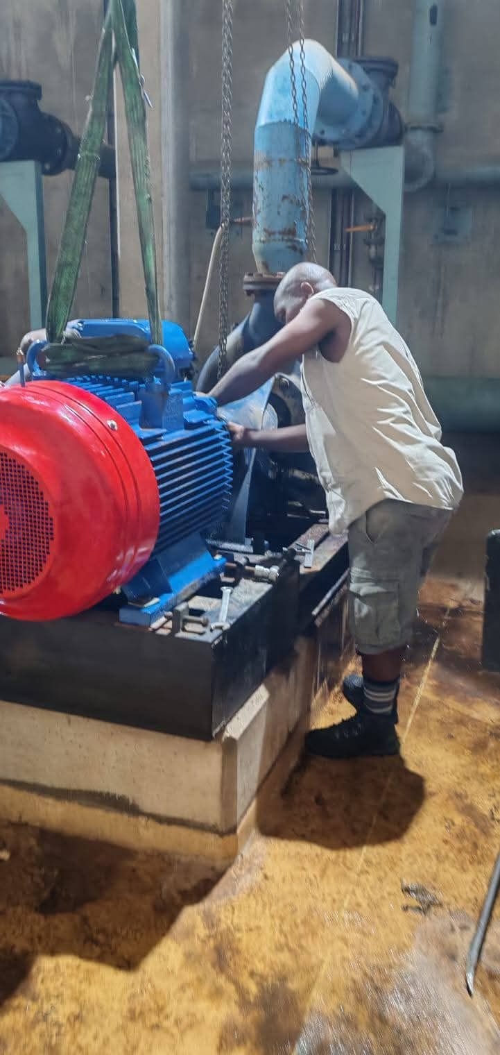 Ethaya technician aligning a heavy-duty electric motor to a water pump